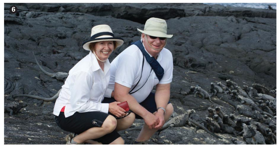 Mrs Caroline Yelland and Dr Joel Yelland with marine iguanas in the background